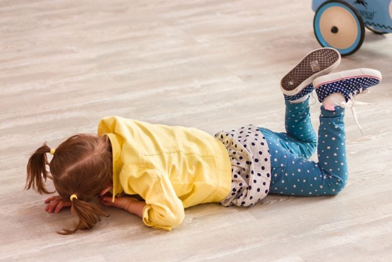 Small girl on the floor throwing a tantrum