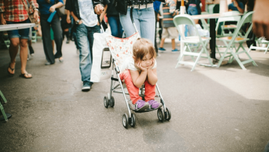 Girl toddler looking bored in stroller: how to discipline your kids less in public