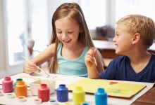 Little boy and girl painting pictures