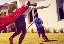 boy running with a superhero cape