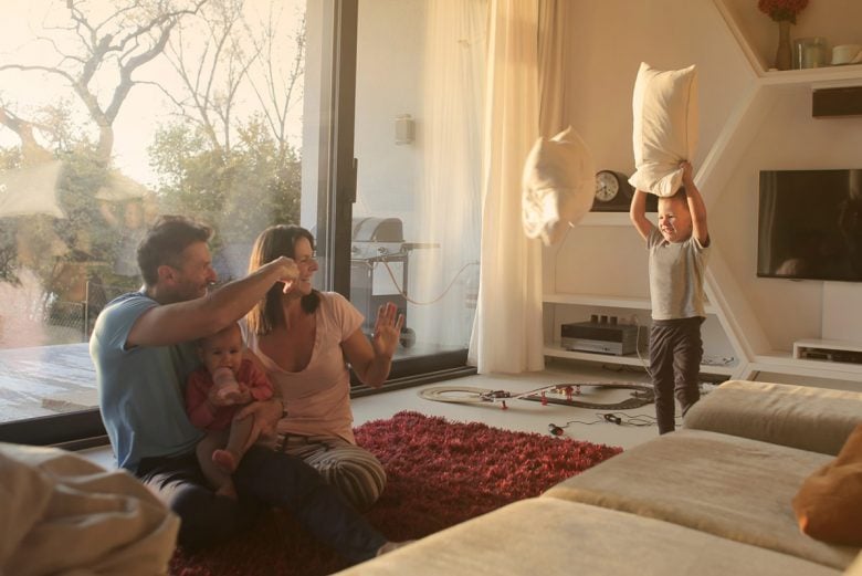 Mom, Dad, and child having a pillow fight