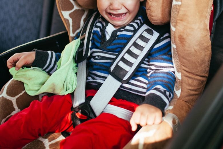 Child crying at being buckled into carseat