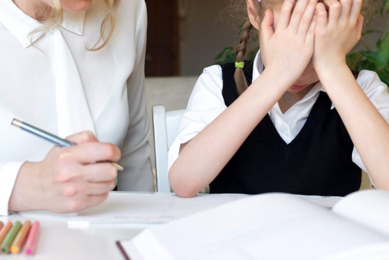Parent helping child with homework and child is frustrated