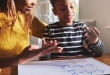 Mother helping child with homework